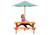 child sitting at picnic table with umbrella