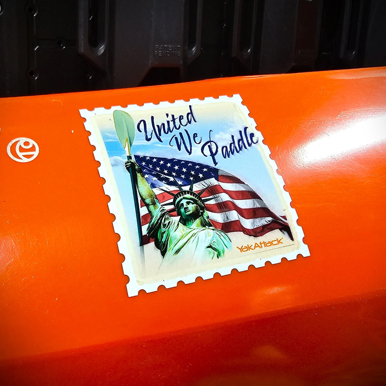 Front view of the United We Paddle Decal, 3" on kayak