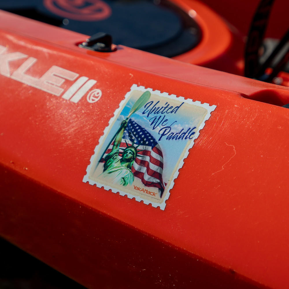 Front angled view of the United We Paddle Decal, 3" on kayak