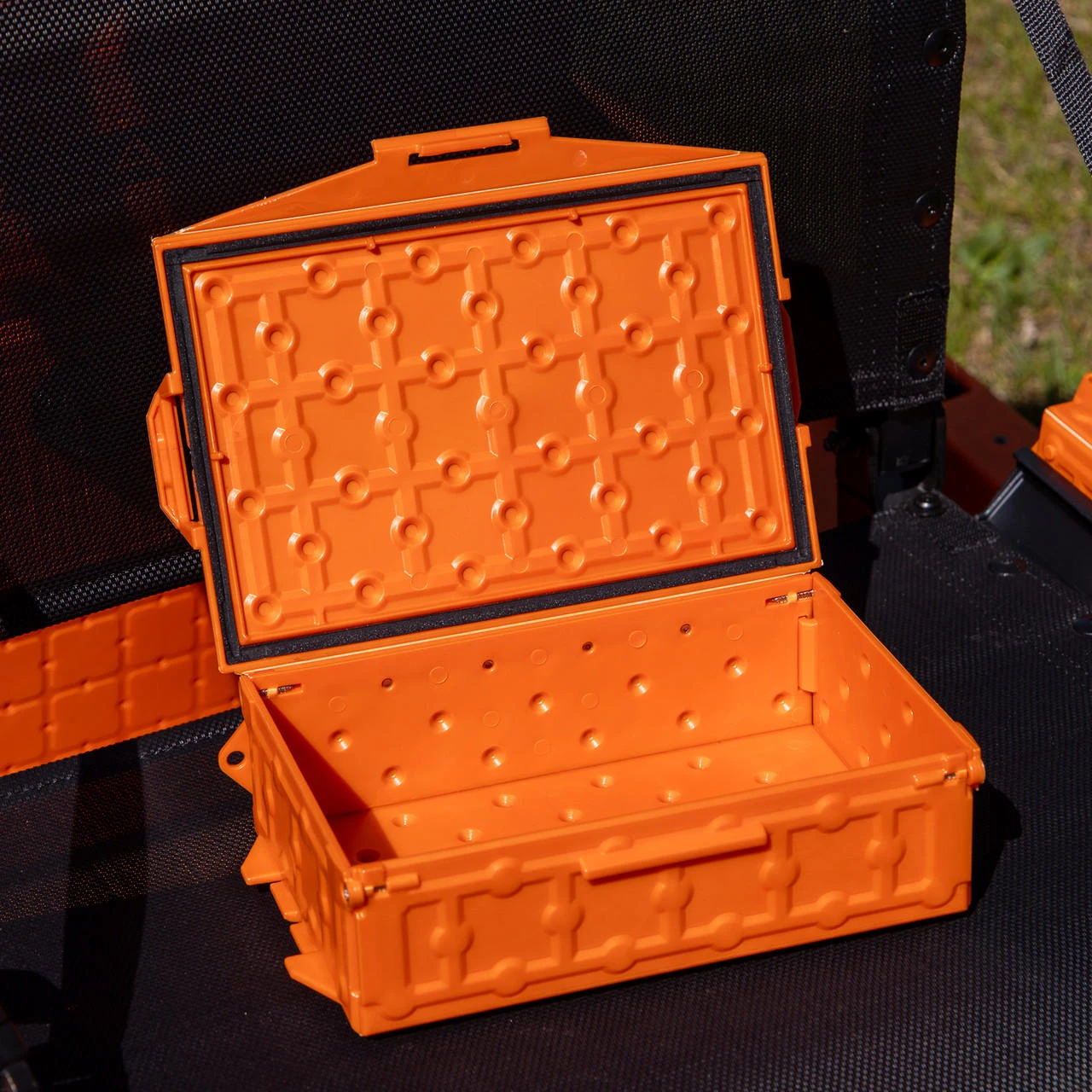 Front angled view of the TracPak Stackable Storage Box, Spare Box, Orange with lid opened