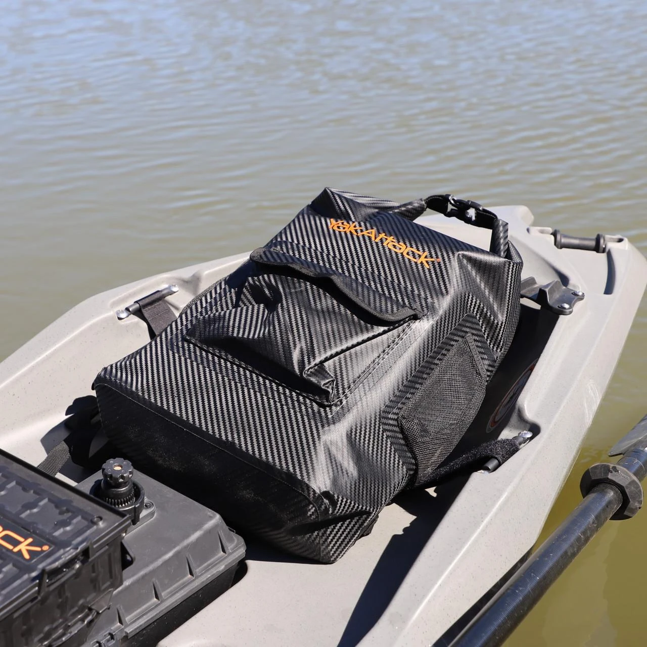 20L Roll-Top Drybag Backpack - Black laying on front of kayak