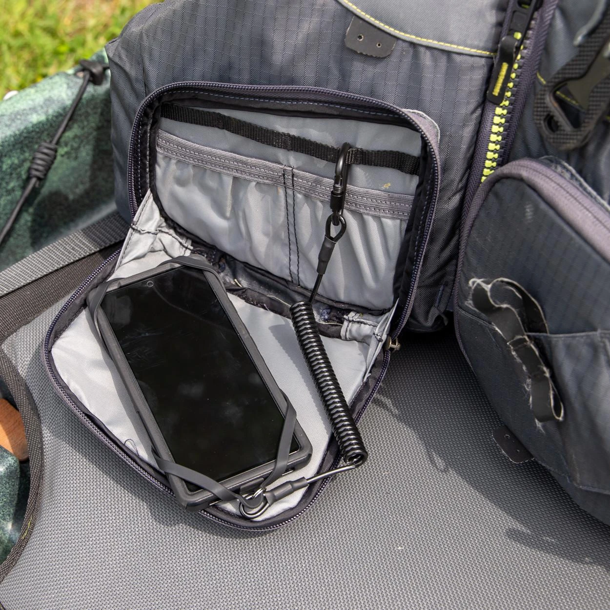 Universal Smartphone Harness with Tether, Black sitting on PFD (2)