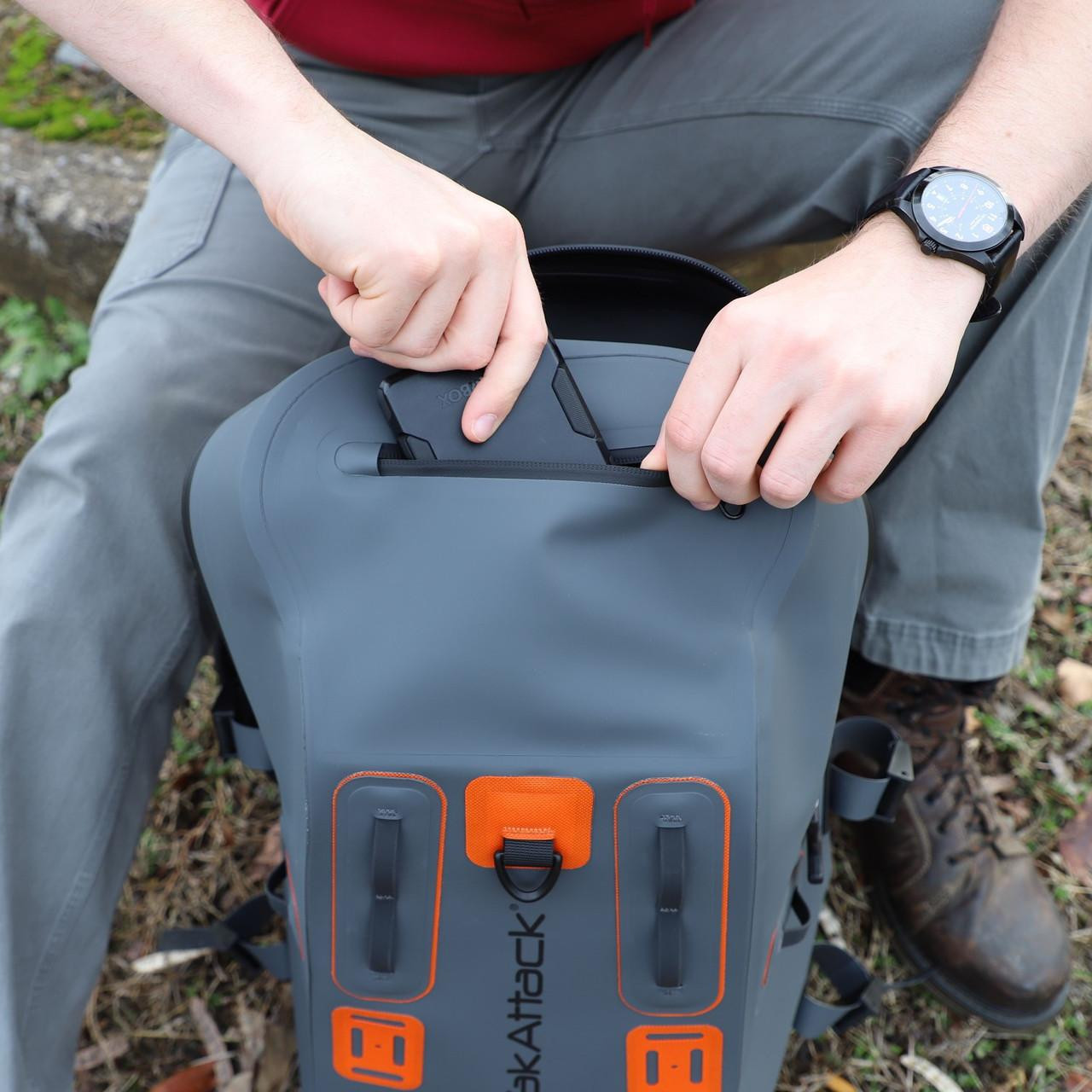 Lifestyle picture of the 28L BackWater DryPak, Waterproof Backpack, Grey/Orange, Includes TetherTubes being used