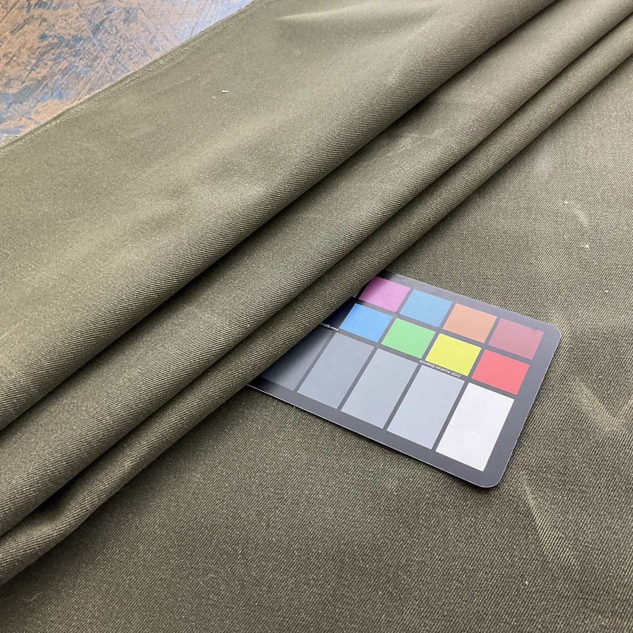 Folded twill fabric in light gray; soft grey material pressed with