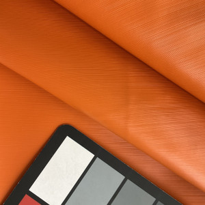 Lightspeed in Orange | Warm Orange Glossy Lined Texture Faux Leather Upholstery Vinyl Fabric | Midweight | Indoor Furniture | Felt Backed |  54 Wide | Sold BTY