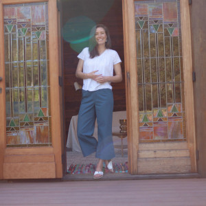 Woman standing in doorway wearing Ansley Eyelet Top in White
