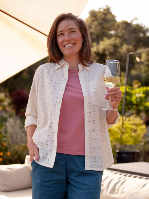 Woman standing outside with wine in hand wearing Magnolia Solid 3/4 Sleeve Top in Dusty Rose Pink