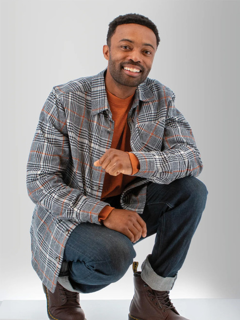 Man kneeling wearing the Miles Organic Cotton Big Shirt in charcoal gray plaid.
