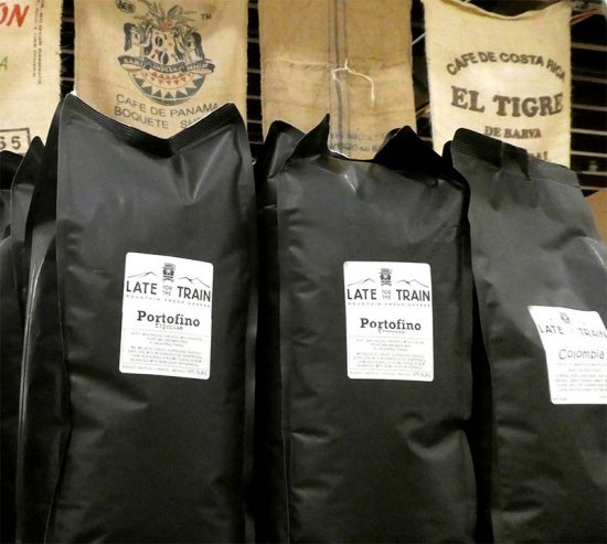 Five pound coffee bags with burlap sacks behind