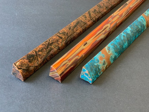 Three inside corner copper trim pieces in blue patina, dark distressed, and multicolored with striped effect