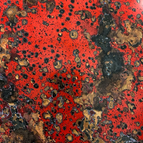 red fuchsia patina copper sheet with a black and brown mottled oxidation pattern
