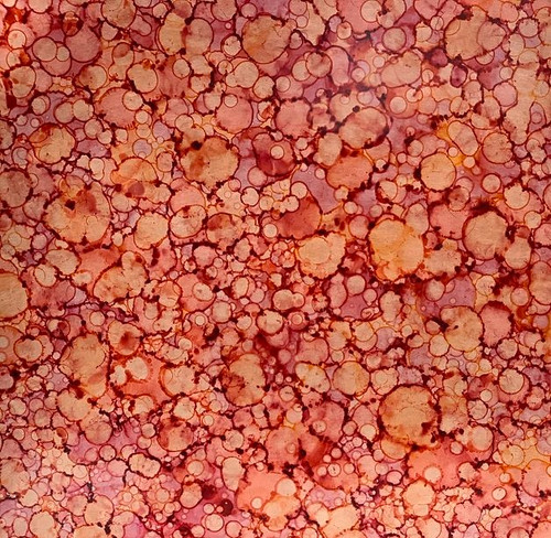 copper with red and orange opaque droplet pattern