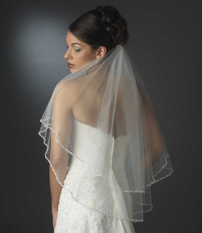https://cdn11.bigcommerce.com/s-zb3qt33o/images/stencil/original/products/15373/60845/Two-Layer-Elbow-Length-Wedding-Veil-with-Beaded-Pearl-Edge_26341__03158.1689477712.jpg
