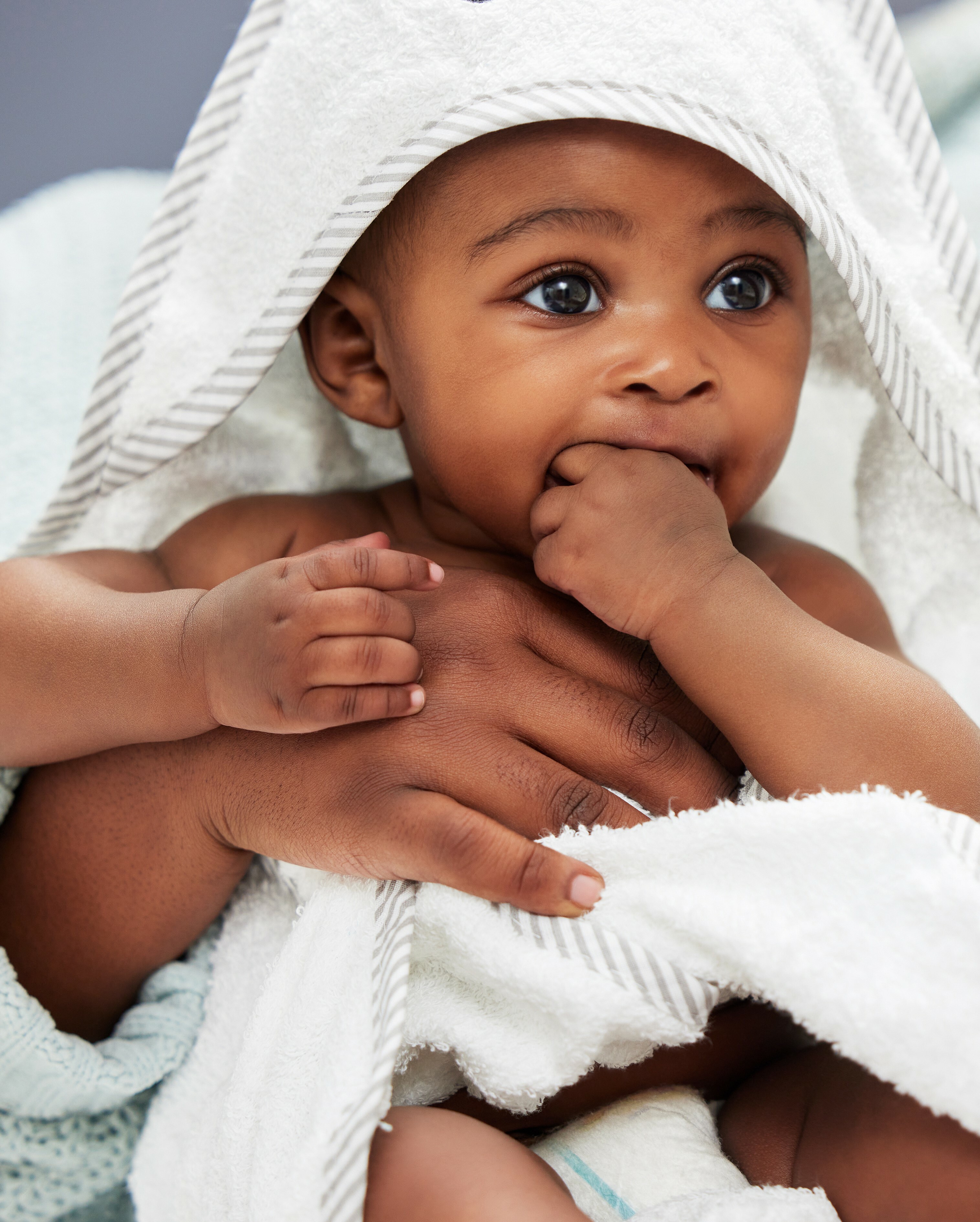 baby wrapped in towel after bath