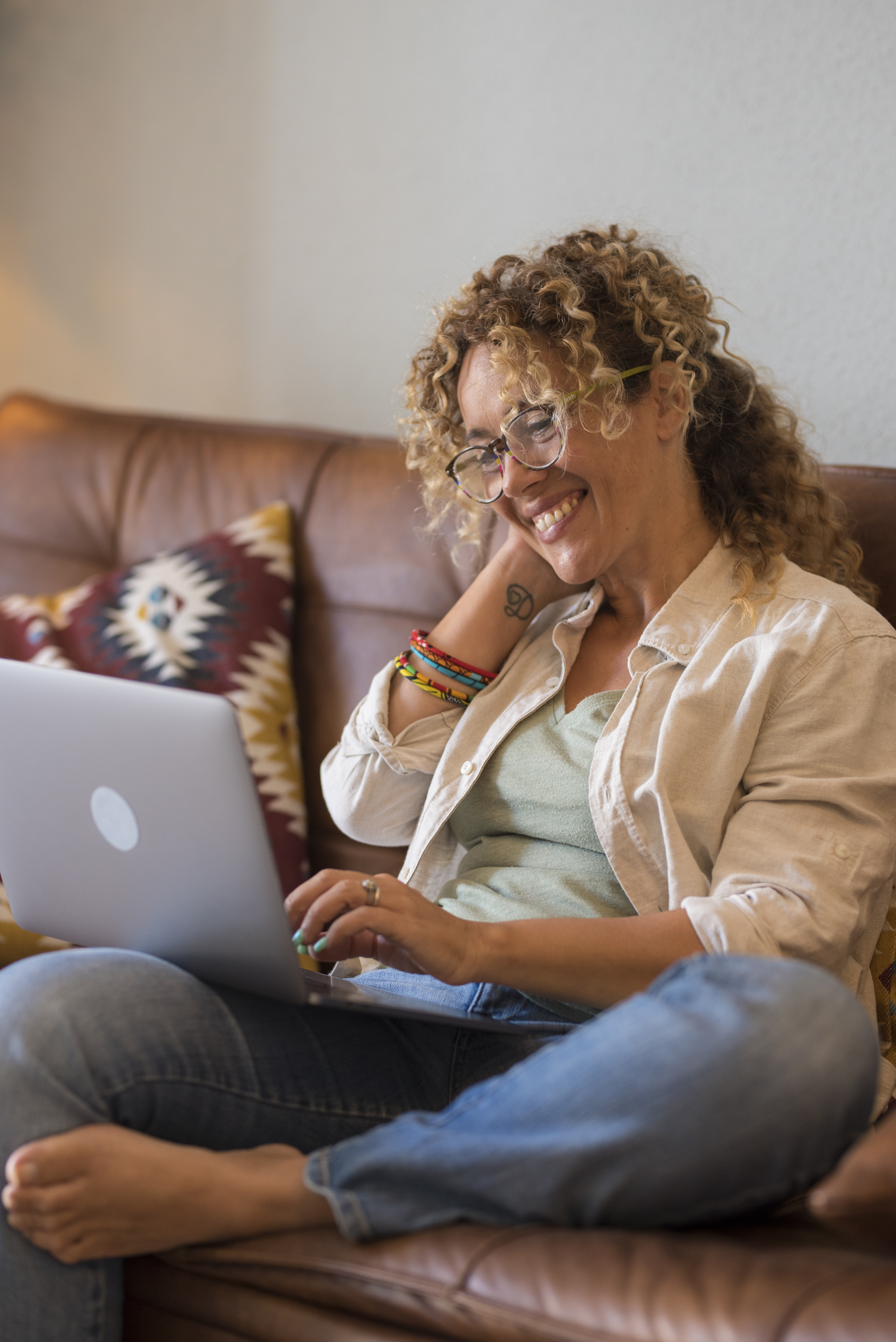 Woman smiling while looking at laptop