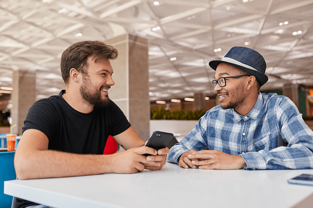 Men talking in a cafeteria. 