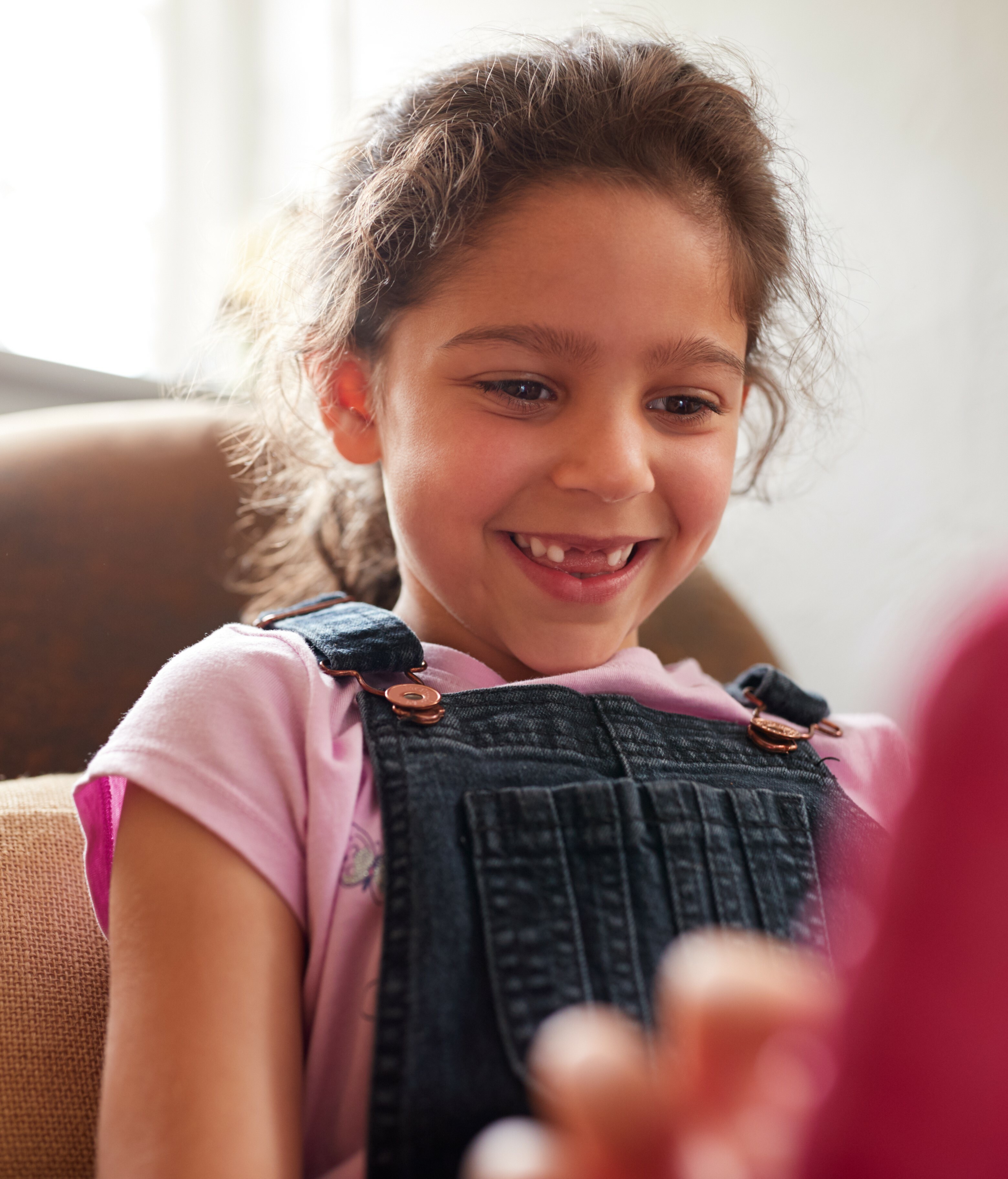 girl smiling while on tablet