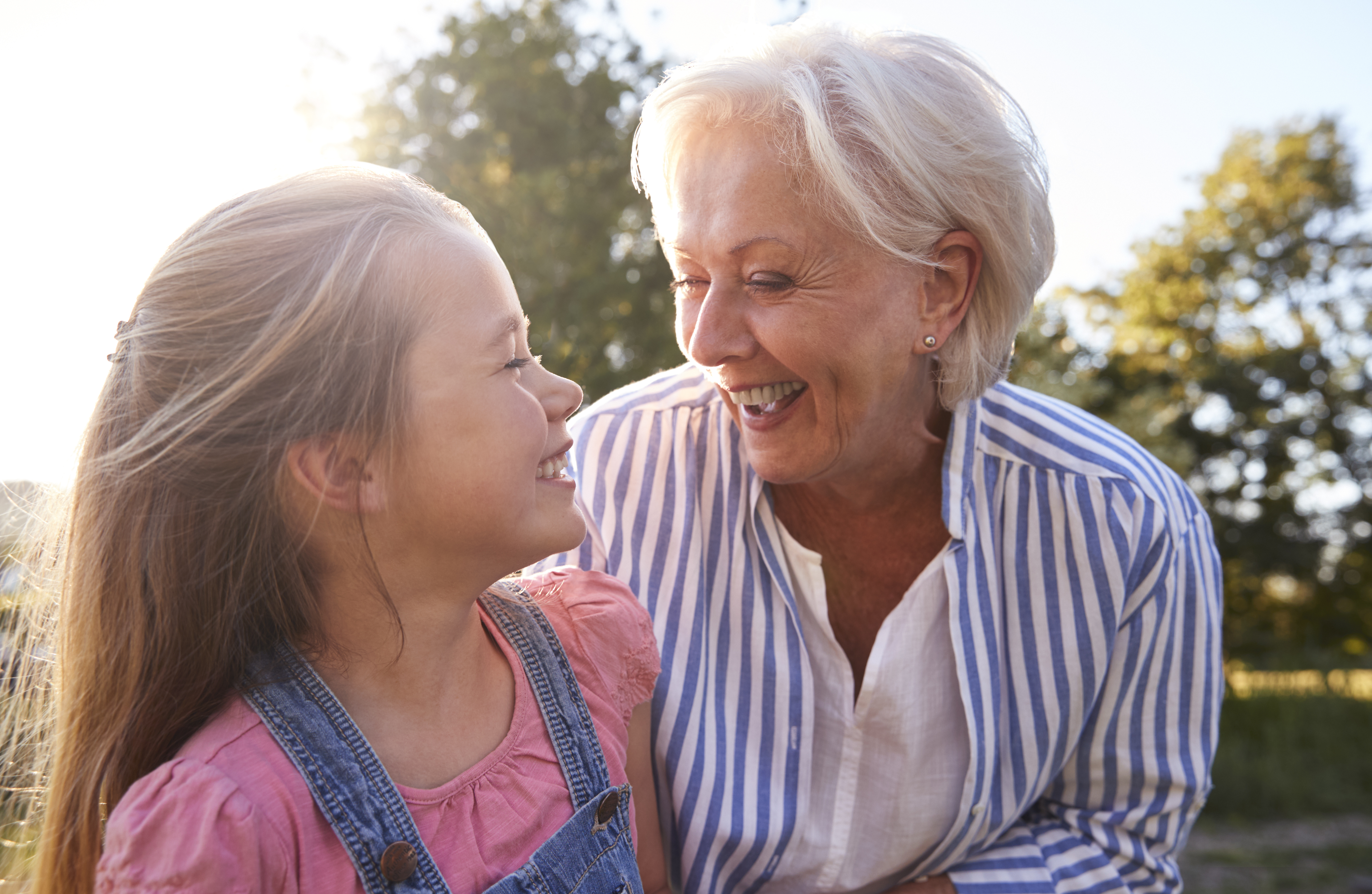 grandmother and child smiling in the sunshine