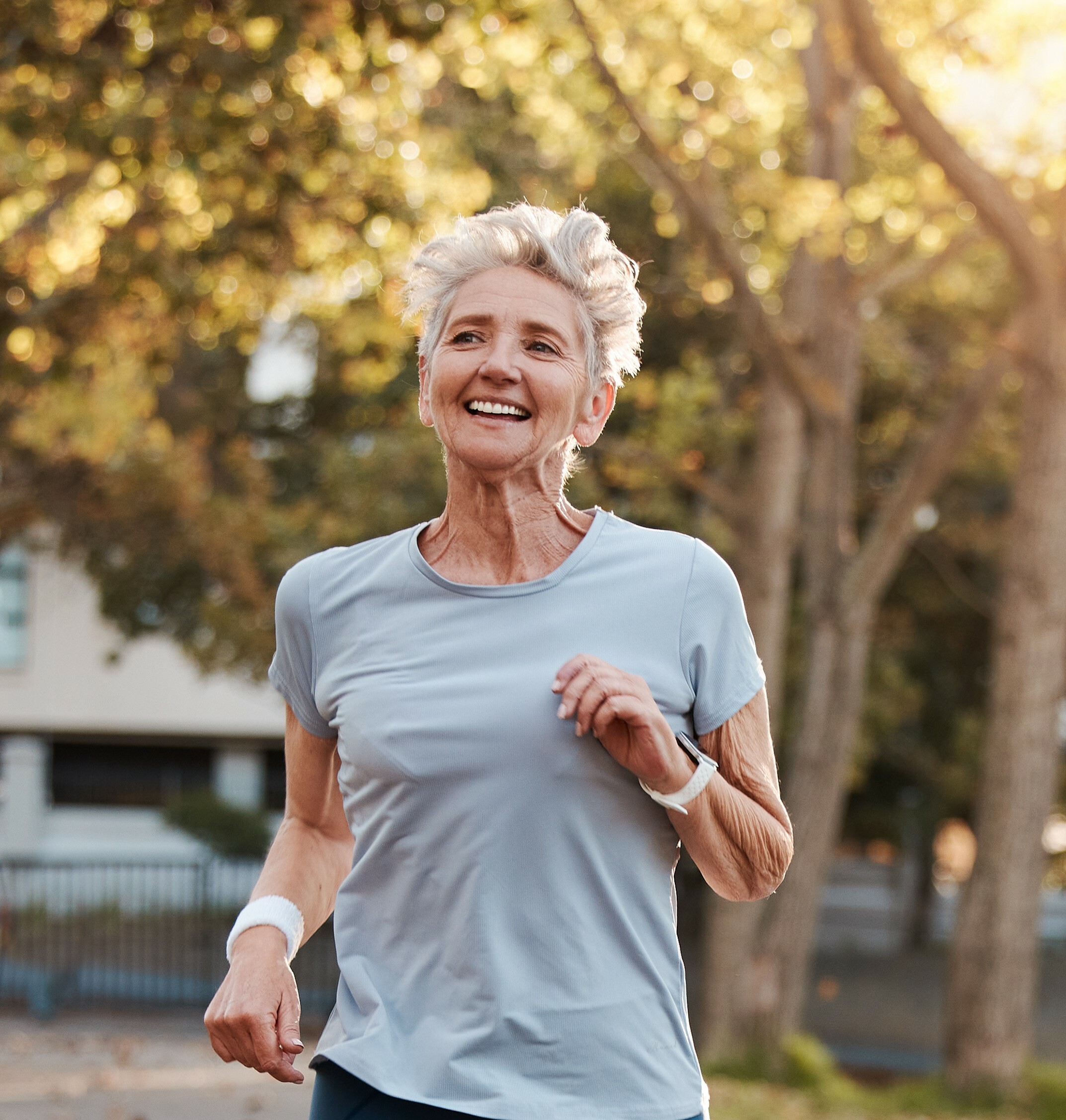woman in her 50's jogging in park