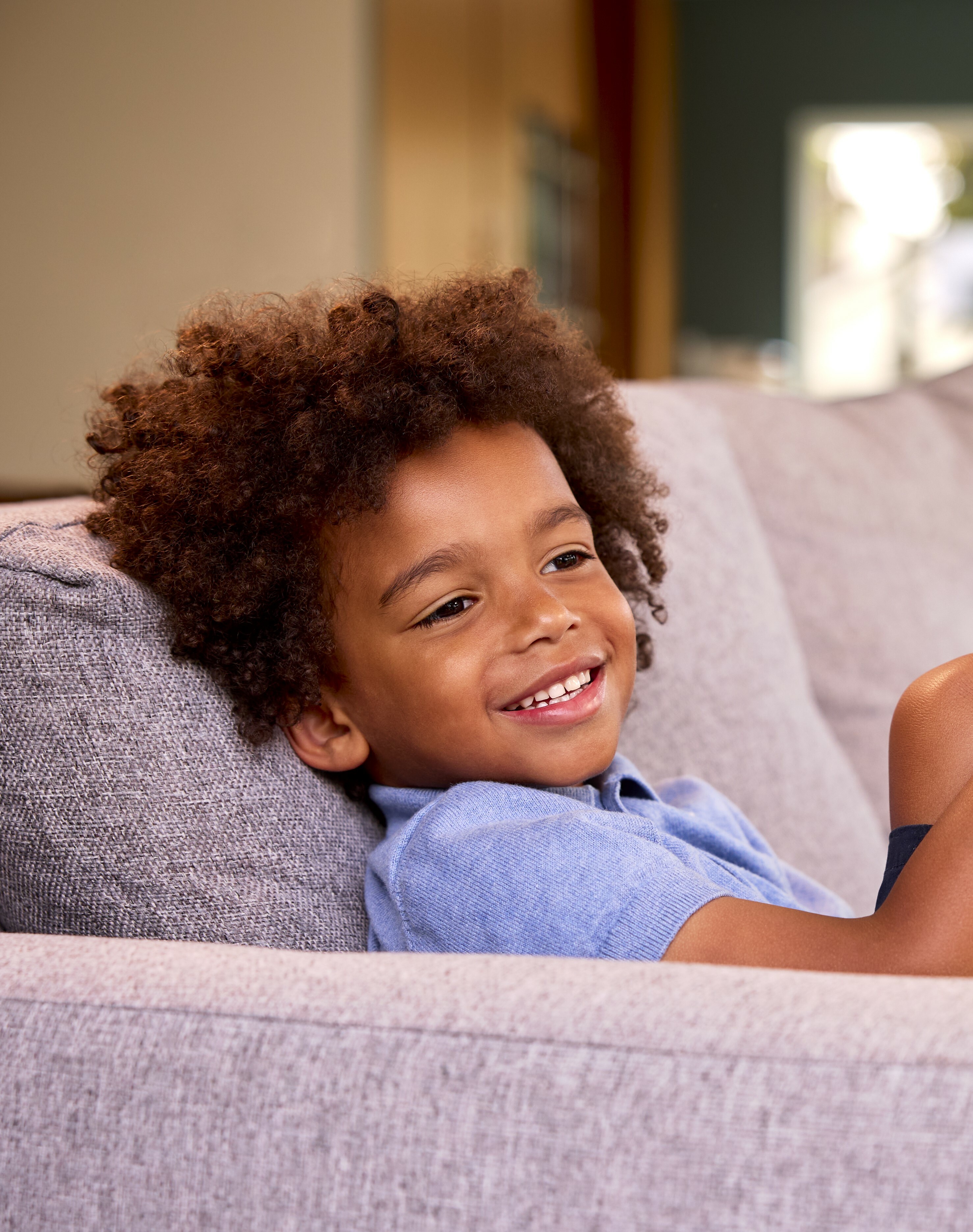 boy on sofa smiling