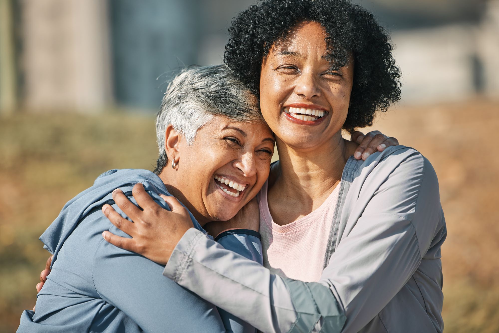 Older woman smiles at friend over coffee