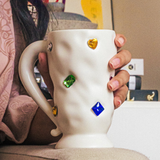 Gemstone Gala Coffee Mug—This Creamy, Off-White Ceramic Mug Is Adorned With an Array of Glittering Gemstone Accents, Creating a Dazzling Spectacle With Every Sip