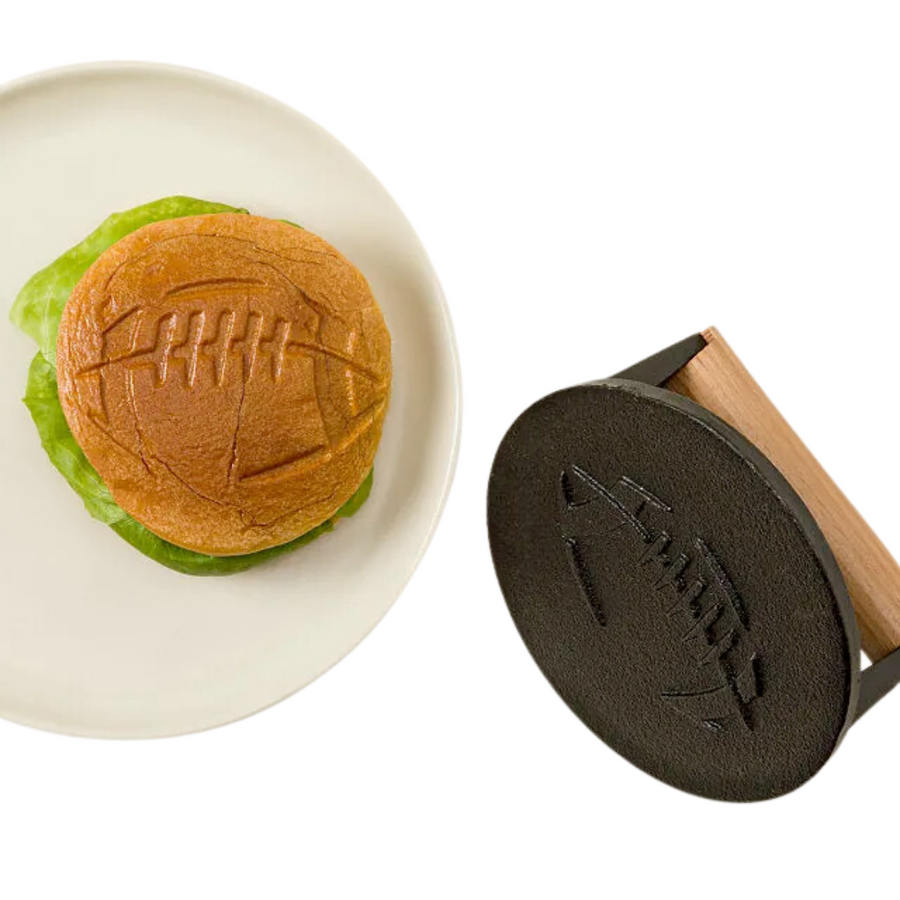 Football Fan Grill Press—Let Gridiron Grillmasters Leave Their Mark On Buns, Veggies, And More With A Football-Shaped Cast-Iron Press