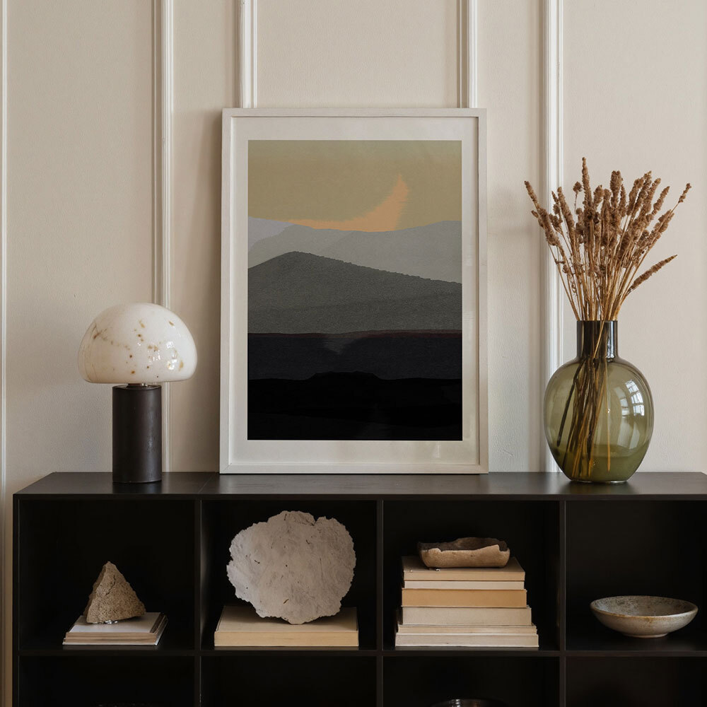 Abstract and contemporary art prints on a black sideboard