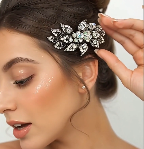 Aurora Petal Barrette: large leaf-shaped crystal barrette in antique silver beside a face