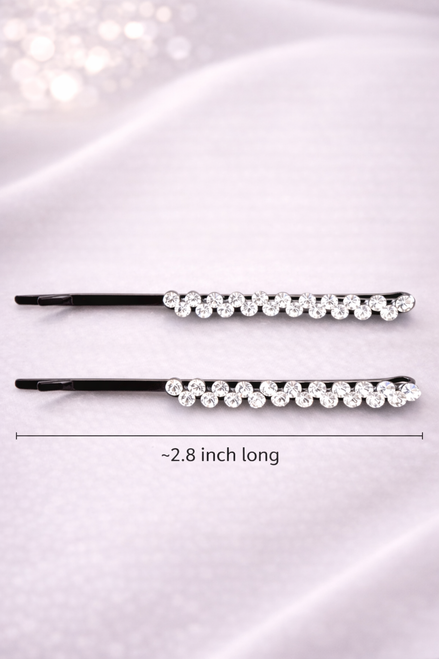 Crystal Line Hair Clips: two slim black clips set with clear crystals on pink fabric, with a length label