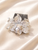 Éclat Blossom Crystal Hair Comb: clear crystal flower comb with a round bead centre on cream satin