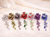 Éclat Rose Garden Crystal Hair Comb colour range: 7 rose combs in a row on satin, different colourways