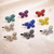 Mini Aurora Butterfly Magnetic Barrette: a range of colours on a sparkle background
