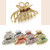 Luxe Arc Crystal Hair Claw: gold-coloured openwork claw above a row of claws in assorted colours