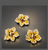 Crystal Bloom Magnetic Barrette: three amber-gold flower barrettes on a dark background