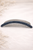 Élise Curve Crystal Hair Comb: dark navy crystal comb on cream beaded surface