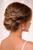Woman seen from behind with a low twisted updo and a small silver sparkling accessory