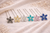 Six flower hairpins in black/grey, champagne, clear, teal, pink and blue on cream fabric