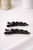 Crystal Bloom Clips: two black clips with small dark crystal flowers on white fabric