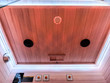 The Trio's ceiling does more than cover. Dual speakers fill the cabin with sound, chromotherapy lighting sets the mood, and a warm reading light completes the atmosphere — three people, one perfectly tuned environment.