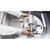Fritsch Grinding Set for Fritsch Vibrating Cup Mill, Agate, 50mL, in use inside laboratory with technician's hands operating the device