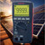 Sanwa Digital Multimeter with True RMS and EF Sensing, measuring AC voltage of 999.9V in a solar power installation.