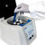 Oxford Lab Products BenchMate Clinical Centrifuge, laboratory centrifuge device with a hand placing a test tube into the rotor for sample centrifugation.