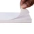 Gilson Company Adhesive Paper for Plastic Limit Roller, case of 1000 sheets, white adhesive paper being peeled off a stack of sheets.