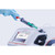 Anton Paar DMA 502 Compact Digital Density Meter, close-up of a person wearing a blue glove inserting a sample into the device for precise density measurement.