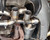 TOP SPEED PRO-1 Valved Cat-Back Exhaust System for Porsche 997.1 Carrera 3.6L / 3.8L NA (2005–2008), shown with quad 89mm (3.5") matte dry carbon fiber tips. Constructed from T304 stainless steel with precision TIG welding and mandrel-bent piping. Includes remote valve control kit with vacuum actuator and key fobs. Actual product shown.