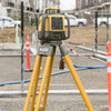 Topcon RL-HV2S rotary laser on a tripod at a jobsite with traffic cones – 1051612-01