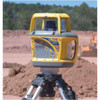 Spectra GL700 series rotary laser on a tripod on an earthworks site, set up as the grade reference for the machines working around it