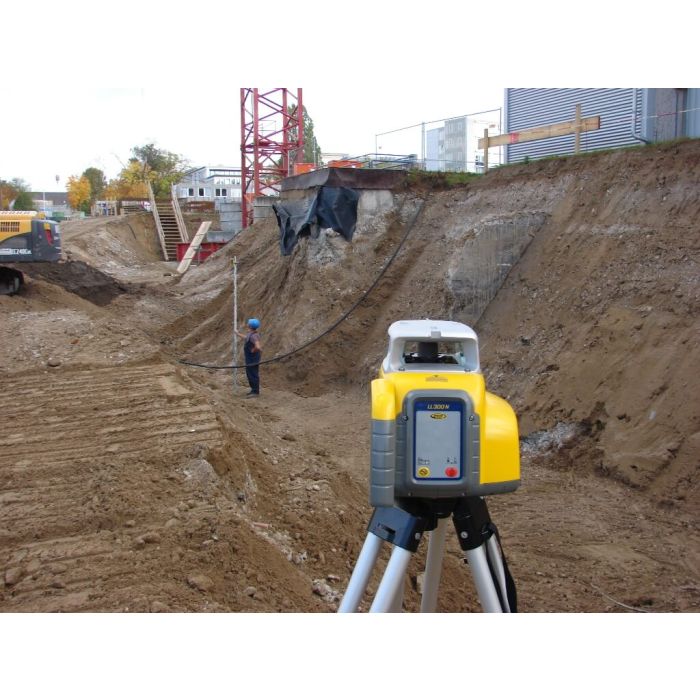 Spectra LL300N rotary laser checking grade over an excavation with a rodman in the cut