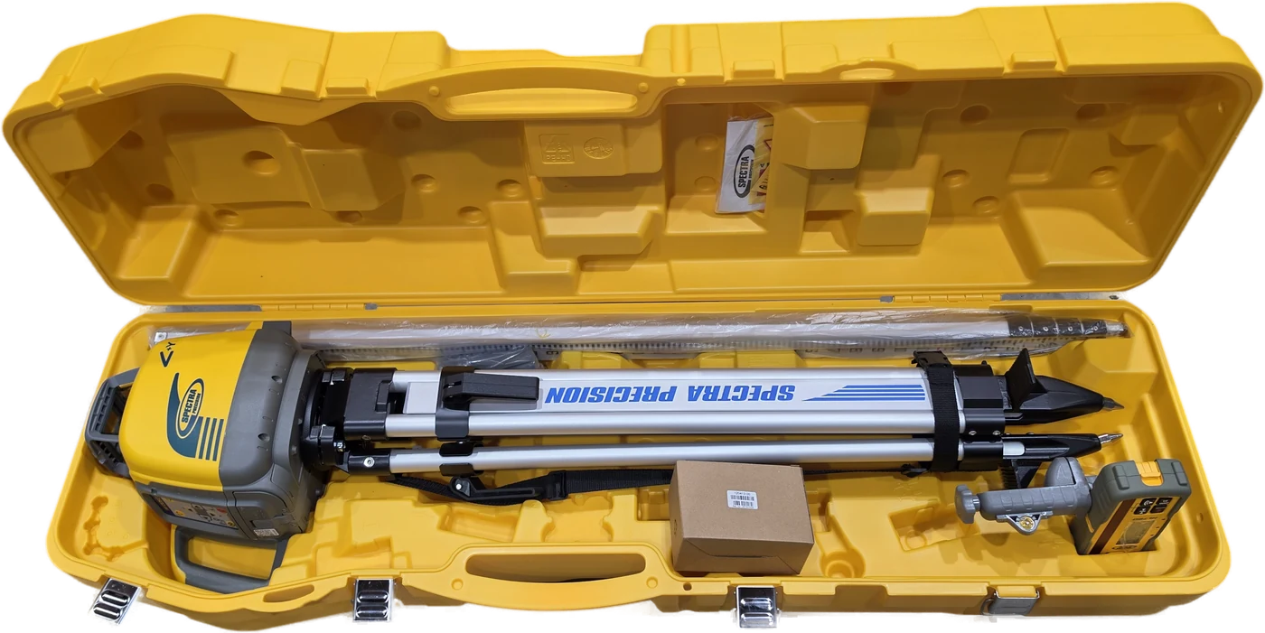 Spectra Precision 128995-00 large All in One system case open and packed &mdash; the LL1505C rotary laser, the Q104025 tripod, a Spectra Precision grade rod and the receiver and charger boxes all stowed inside the one molded case